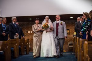 Walking down the aisle with Mom and Dad.