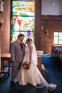 Standing in front of the floor-to-ceiling stained glass piece.